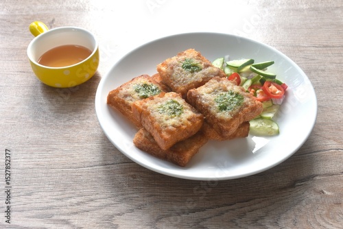 Thai crispy fried pork toast on plate eat couple with pickled vegetable sauce