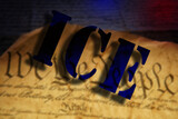 ICE - Immigration and Customs Enforcement - text over We The People text on the US Constitution