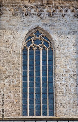 stained glass window on ancient stone wall