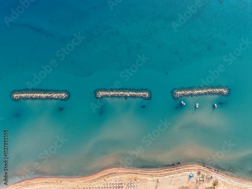 Aerial View of Coastal Rock Formation Above Turquoise Sea