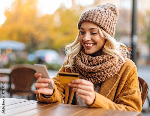 Woman using phone and credit card outdoors