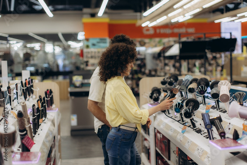 Couple Shopping for Hair Dryers in an Electronics Store