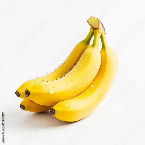 Fresh yellow bananas with water droplets against a white background, showcasing their vibrant color and natural texture.