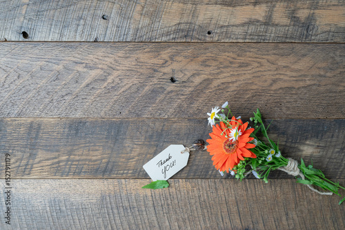 Thank you, message note text, with fresh flower bouquet.