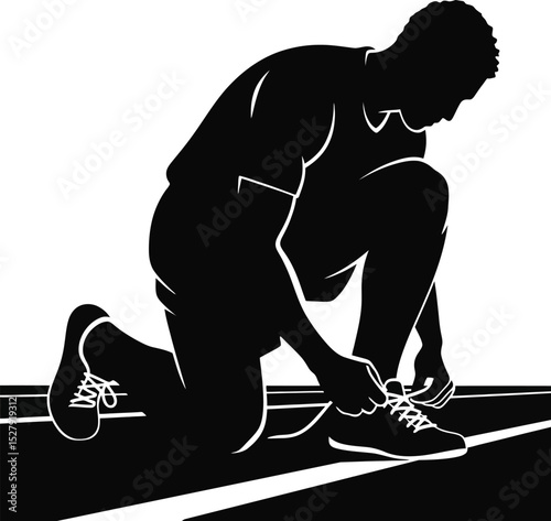 A silhouette of an athlete kneeling and tying his running shoe on a track preparing for a race event