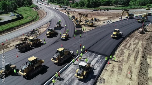 Wallpaper Mural Construction workers paving a new road with heavy machinery   Torontodigital.ca