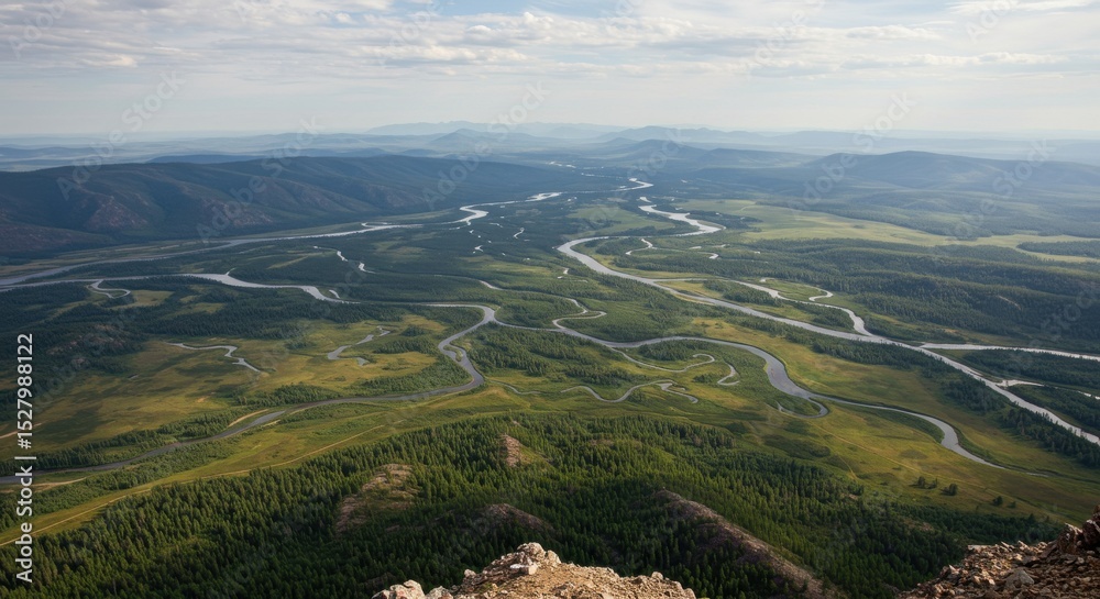 Fototapeta premium Elevated view Green valleys and winding river under bright, cloudy sky
