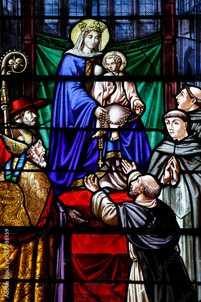 Fototapeta premium Saint Pierre church. Stained glass. Saint Dominic receiving the Rosary from the Virgin. Toucy. France.