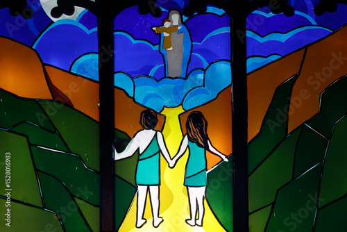 Kon Tum Cathedral, also known as Wooden Church.   Stained glass window.  Adam and Eve, expulsion from Paradise. Kontum. Vietnam.