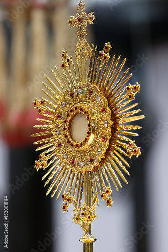 Monstrance for worship at a Catholic church ceremony.  Adoration to the Blessed Sacrament,  Eucharistic celebration. Corpus Christi.  Kon Tum Cathedral, also known as Wooden Church.  Kontum. Vietnam.