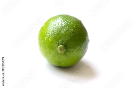 Fresh, vibrant green limes on a clean white surface. Juicy citrus fruits symbolizing summer freshness and healthy living. Selective focus creates a bright, inviting mood.