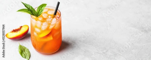 A refreshing peach iced tea garnished with fresh mint leaves and a straw, accompanied by a peach slice and mint on a light textured surface.