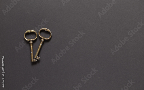 Antique metal keys on a dark insulated background