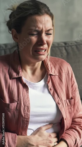 Woman crying on couch wearing headphones with slow dolly in soft natural lighting empty space top right

