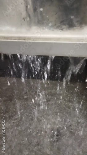 Heavy Rain Falling Below Window and Flooding Backyard Floor
