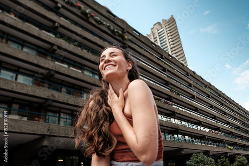 Photography Young woman smiling in front of the barbican estate in london