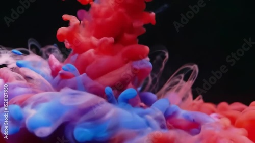 Abstract Red Pink Blue Ink Swirling in Water Artistic Fluid Motion Background