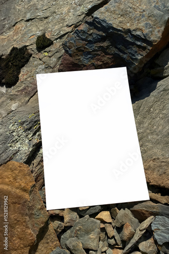Mockup of white A4 sheet with shadows on large mountain stones in diffused sunlight. Layout of poster on stone background. White blank with space for text or design