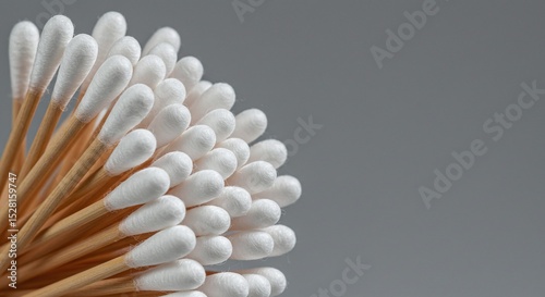 Close-up bundle of white cotton swabs hygiene products isolated on a grey background