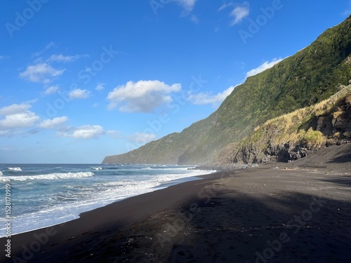 Serene Black Sand Beach with Lush Green Cliffs and Blue Sky on azores island
