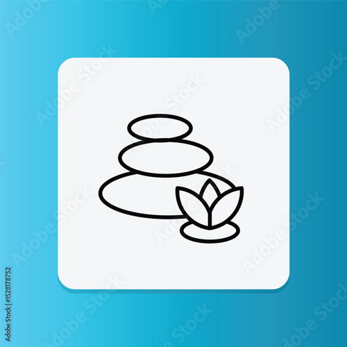 Stacked spa stones and a lotus flower, symbolizing relaxation and self-care.