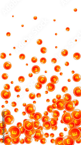 Vitamin E round capsules scattered randomly.