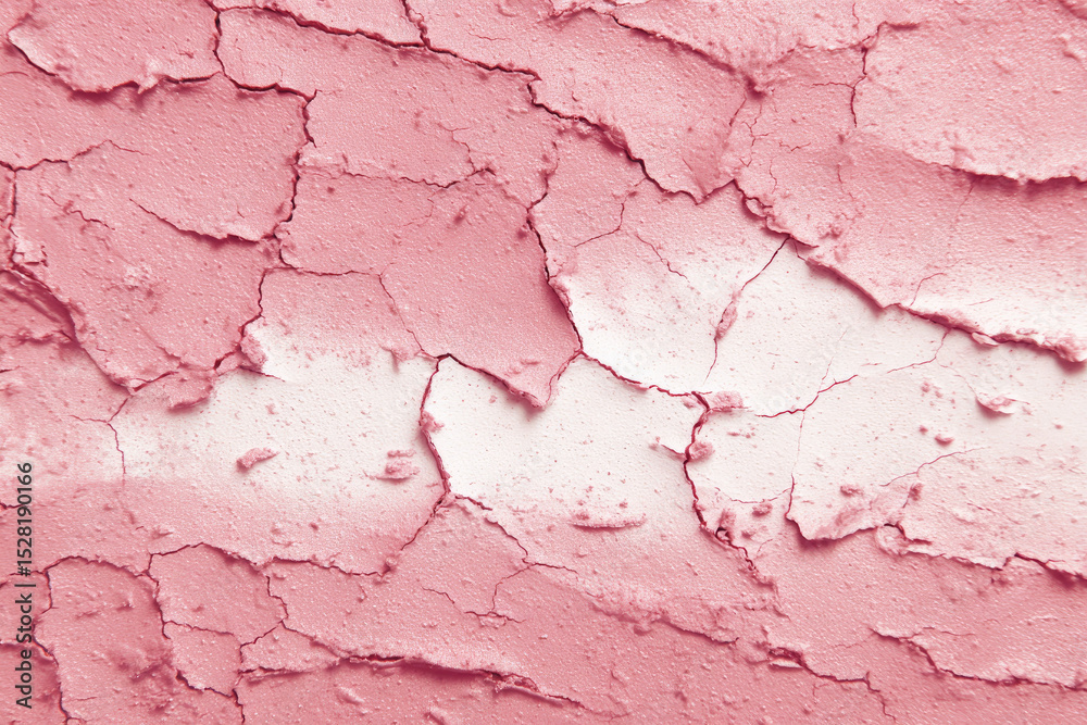 Fototapeta premium Cracked pink clay mask texture with dry effects, showcasing abstract pattern. surface appears rough and textured, creating visually interesting design