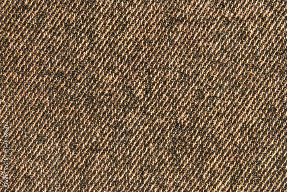 Brown denim cotton twill fabric pattern close up as background Brown denim cotton twill fabric pattern close up as background
