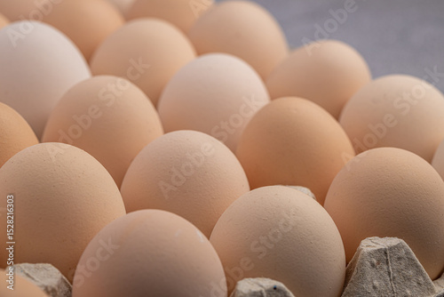 Brown eggs stacked in rows.Group of Fresh white Eggs in a cardboard cassette. Organic food from nature good for health.