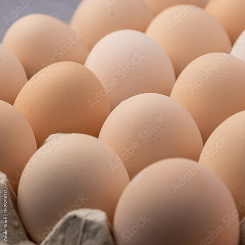 Brown eggs stacked in rows.Group of Fresh white Eggs in a cardboard cassette. Organic food from nature good for health.