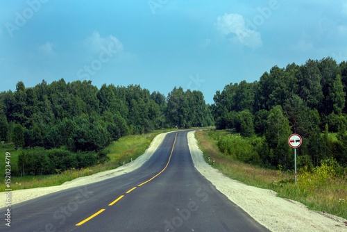 Highway outside the city among the forests