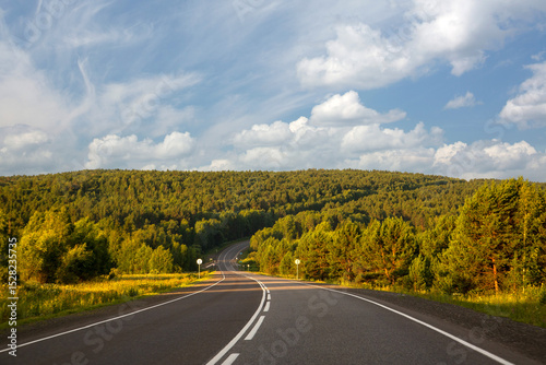 Highway outside the city among the fields and forests