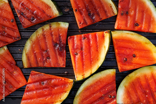 Grilled watermelon slices on a grill plate, close up view, top view