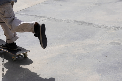 Image of just someone's legs on a skateboard