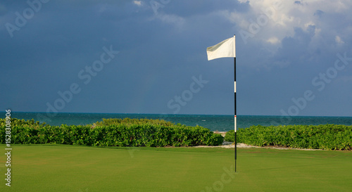 Golf flag and green at tropical Golf Resort.