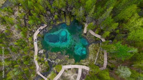Beautiful turquoise geyser lake in the Altai Republic. Landmark - Geyser Lake, drone view