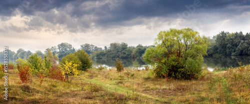 Wallpaper Mural Autumn river landscape with colorful trees and bushes under a cloudy sky Torontodigital.ca