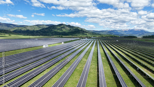 Solar power plant in the mountains. Thousands of solar panels. Renewable energy in remote mountainous regions. Clean energy from the sun. Rows of solar panels at a power plant.