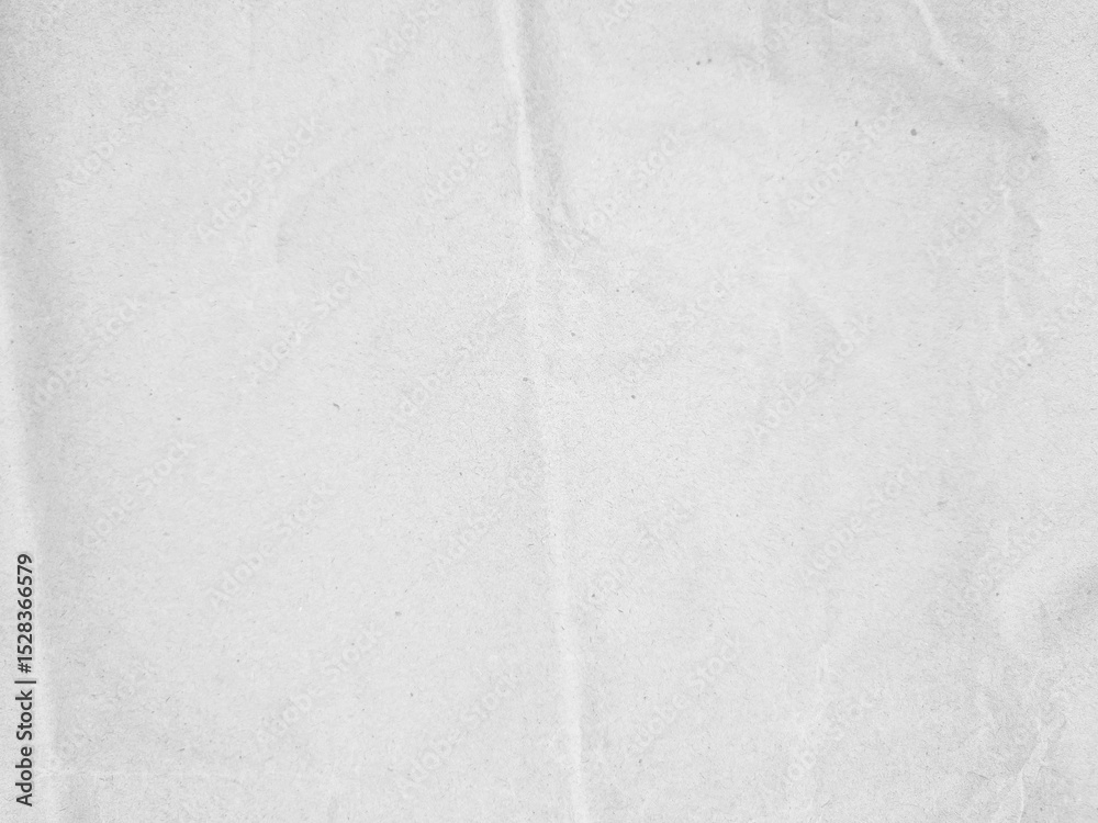Fototapeta premium Crumpled textured white paper with subtle folds and creases, perfect for background use in design projects or presentations. The image portrays a natural, slightly wrinkled surface