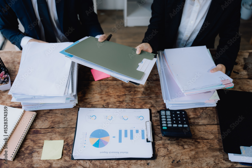 Fototapeta premium Business Professionals Reviewing Documents and Financial Data