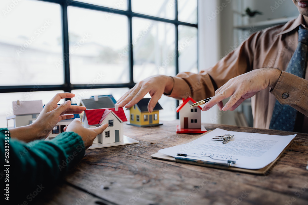 Obraz premium Real Estate Deal with Miniature Houses