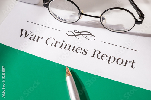 A legal document detailing allegations of war crimes is presented on a desk alongside a gavel and pen, symbolizing international justice and accountability photo