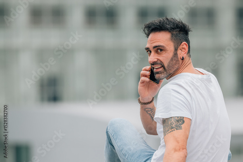 casual style young man on the street with mobile phone