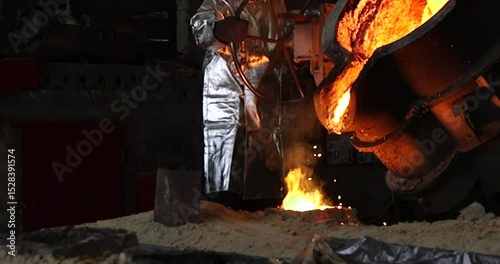 Welding work in a metallurgical plant, workers in protective clothing and masks