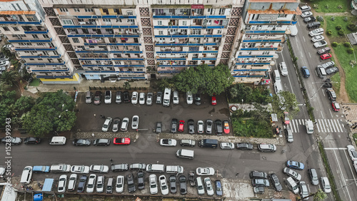 Valokuva Aerial view of a Soviet-era apartment building and crowded parking lot in Batumi