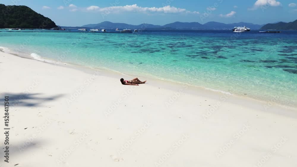 Relax on the beach. Vacation on the sea coast. Young woman enjoying her vacation on the white sand on the coast. Tropical vacation content Relax on the beach. Vacation on the sea coast. Young woman enjoying her vacation on the white sand on the coast. Tropical vacation content