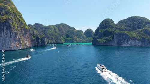 Yacht vacation. White beautiful yacht moving to Phi Phi islands, vacation on board white yacht, drone view 4k. Luxury yacht moving on blue sea, aerial view of vacation shots