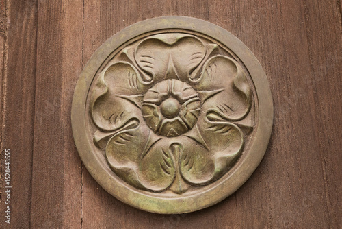Italy, Calabria, Tropea. Bronze medallion with flower design.