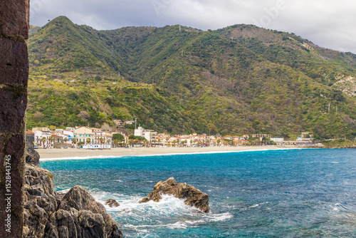 Italy, Calabria, Scilla. Scilla beach, rocks at the edge of the sea. Looking west towards the main beach and the town.