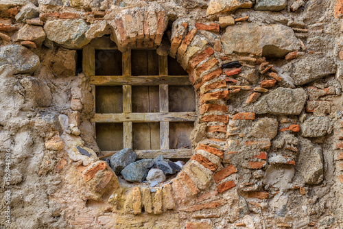 Italy, Calabria, Scilla. Weathered wall and window of brick, stone, and wood.